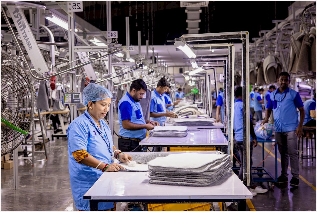 Workers are busy in an industrial garment factory.