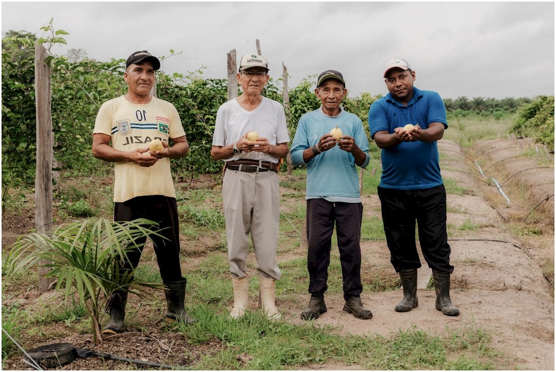 A group of men standing next to each other on a dirt road