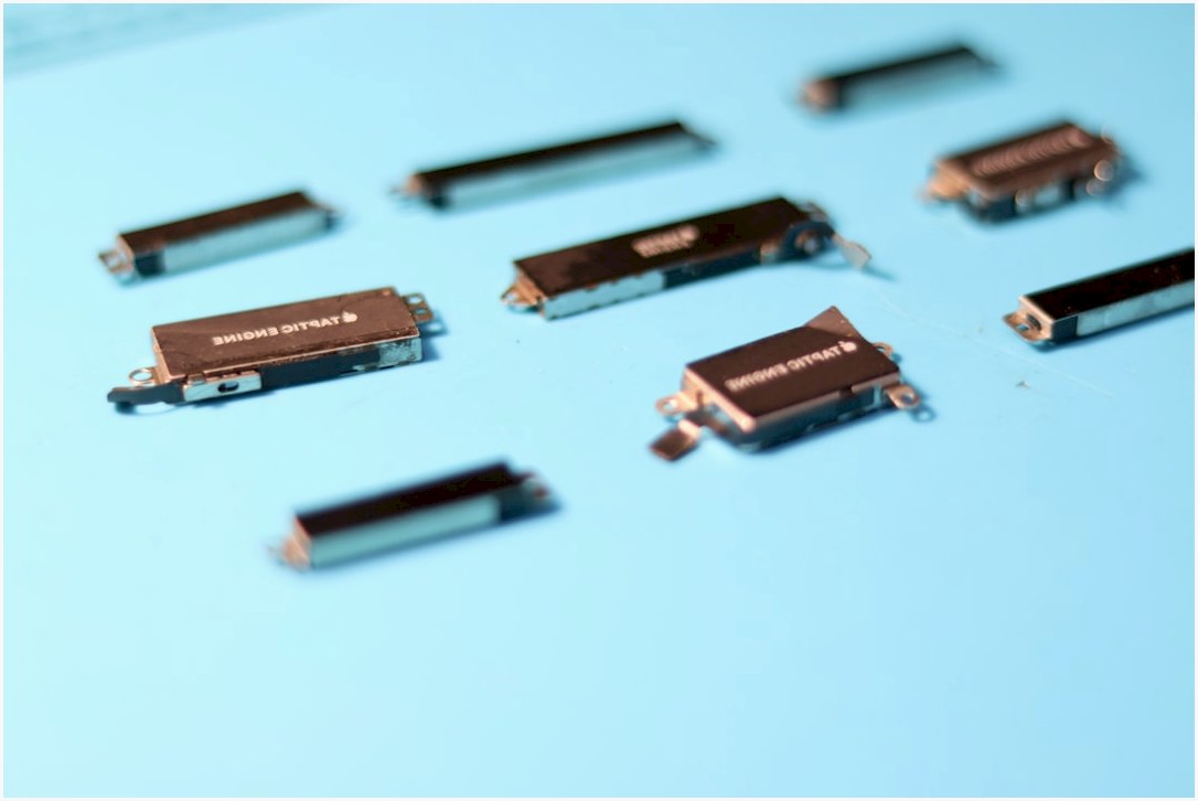 Electronic components are arranged on a blue surface.