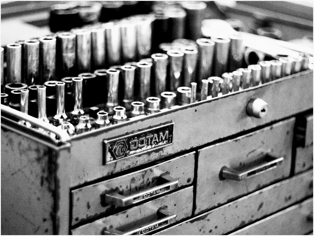 a metal tool box filled with lots of screws