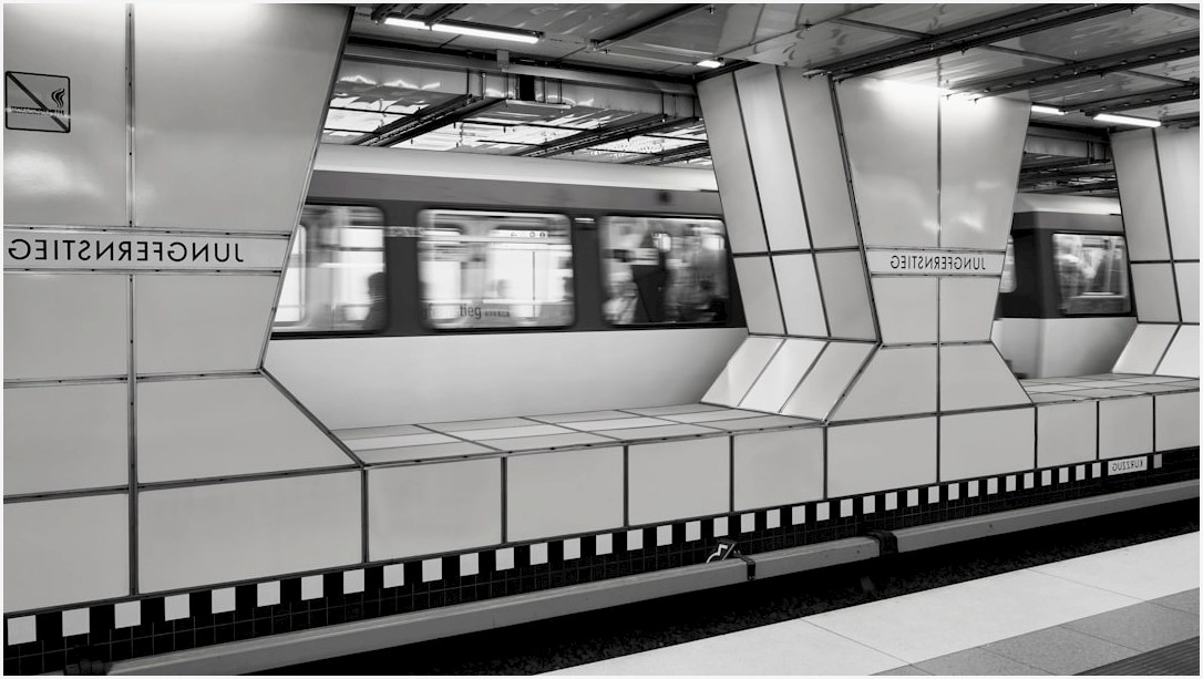 A subway train whizzes through a modern station.