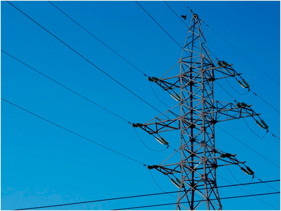 a high voltage power line with a blue sky in the background