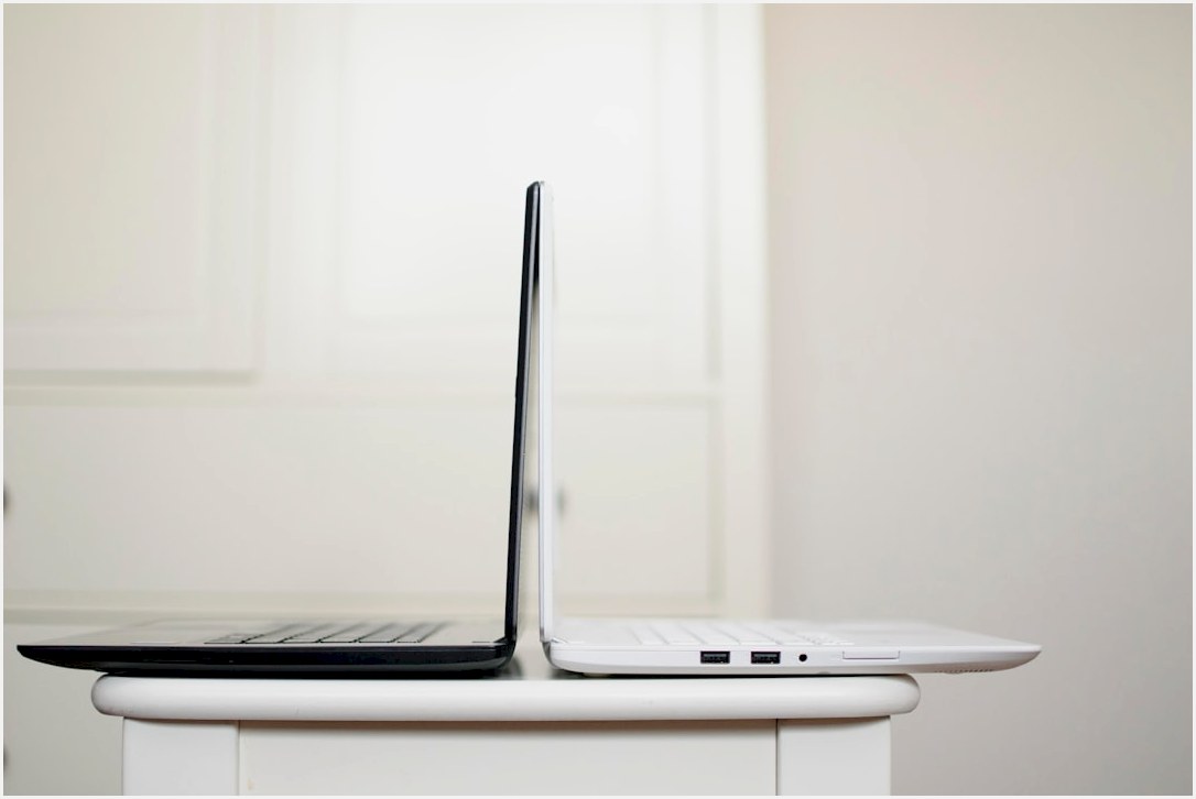 black and white laptop on table back to back