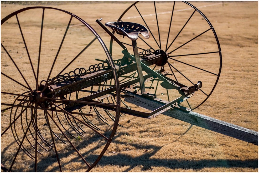 black and gray farm equipment on brown open field