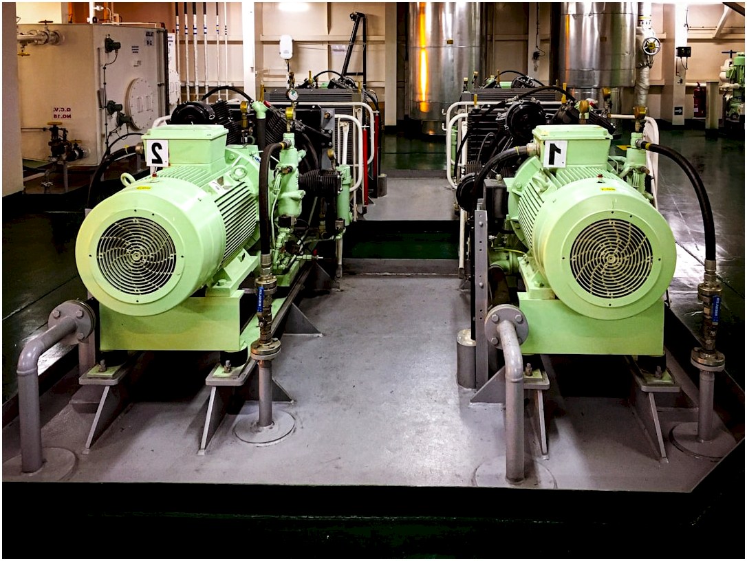 a couple of green machines sitting inside of a building